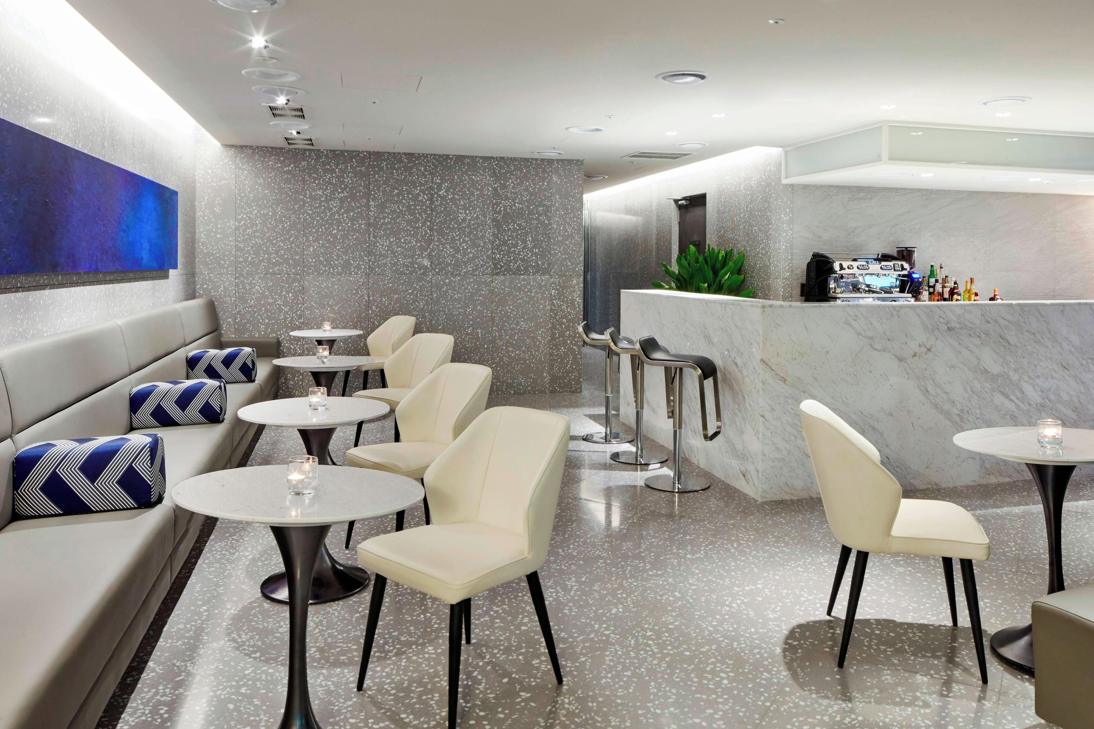A modern bar area with seating and a counter.