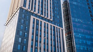 A high-rise building with a modern architectural design, featuring a mix of glass and concrete facades. - Sky Loft Hotel by Rixwell (Kyiv)