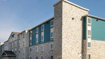 A multi-story hotel with a stone facade and teal-colored upper sections.