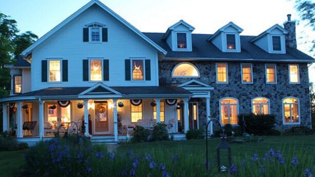 A large, two-story house with a porch and multiple windows. - Maple Shade Bed & Breakfast  (Stillwater)