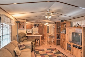 The cozy trailer cabin features comfortable furnishings and rustic decor.