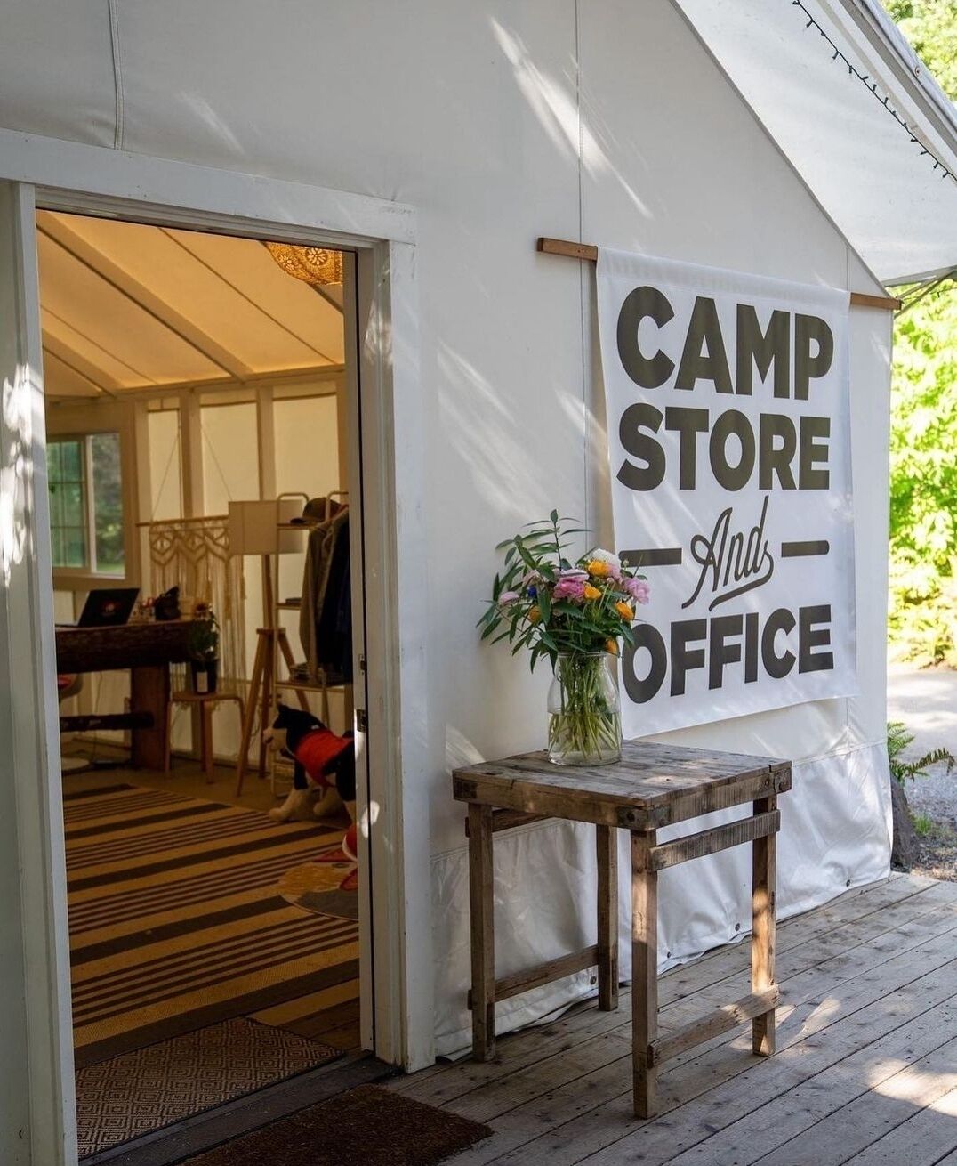 A tent with a sign reading "CAMP STORE And OFFICE".