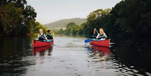 Two red boats on a calm river surrounded by dense greenery. - Delightful cottage set in the pretty village of Clearwell, Forest of Dean.  (Clearwell)