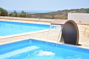 A swimming pool with a water feature. - Carabollace Estate - Mistral (Sciacca)