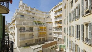 A multi-story residential building with balconies, a courtyard, and a clear sky. - Minuet - 1 bedroom apartment (Nice)