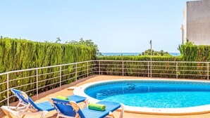 A rooftop swimming pool with blue lounge chairs and a view of the sea. - Villa Marcolis Mar - Four Bedroom Villa, Sleeps 6 (Serpentona)