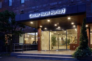 The exterior of Center Hotel Narita 1 with a modern facade, glass entrance, and a well-lit entrance area. - Center Hotel Narita 1 (Narita)