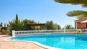A swimming pool with a tiled deck and a white fence with decorative elements. - Casa Winter Garden, popular with our regular guests (L'Ametlla de Mar)