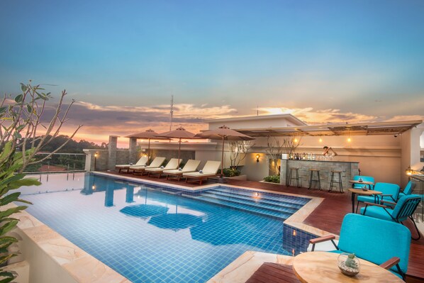 Outdoor pool, open 10 AM to 9 PM, pool umbrellas, pool loungers