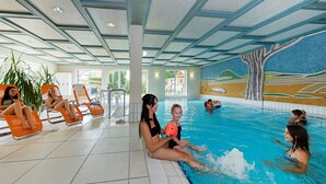 An indoor swimming pool with tiled floors and a mural on the wall. - Gasthof Hotel zum Ochsen (Berghülen)
