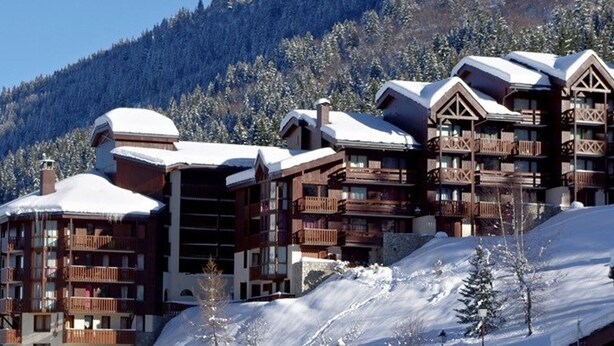 A ski resort with wooden buildings, balconies, and snow-covered roofs. - Comfortable 1-Bedroom Apt with Balcony, Pets Allowed in Valmorel (Valmorel)