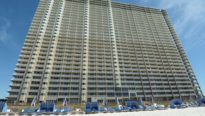 A tall hotel with multiple balconies and a beachside location. - BOOK SUMMER NOW. GREAT RATES! Gulf-Front Master w/Balcony + PRIVATE Bunkroom (Panama City Beach)