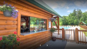 A wooden cabin with a pool area, a bar, and a wooden deck. - Big Sky, Breathtaking Mtn View, Free Attraction Tickets, Pool Table, Hot Tub!!! (Sevierville)