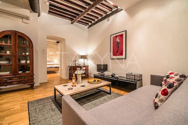 A modern living room with a sofa, coffee table, and a wooden cabinet.