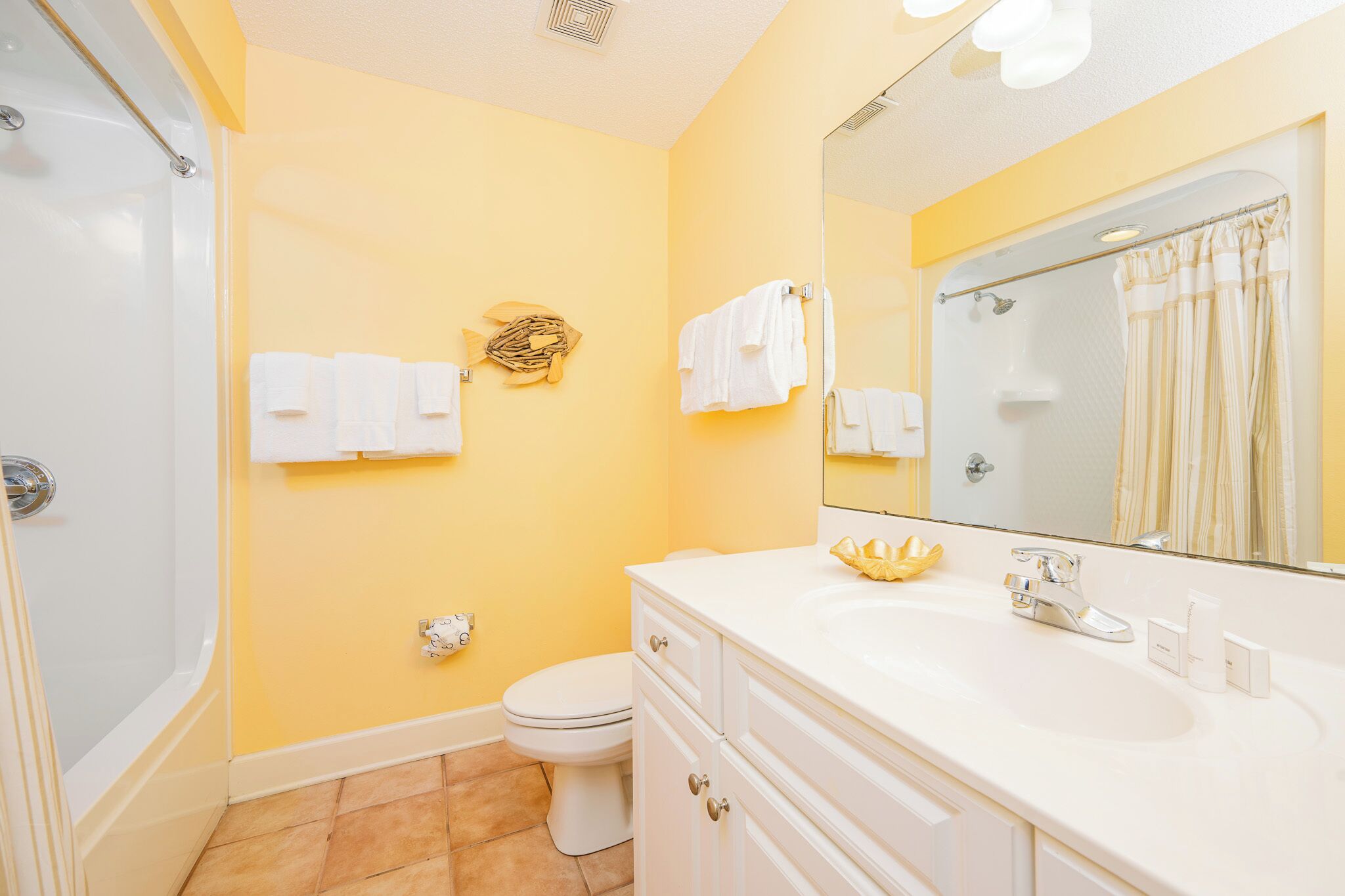 A bathroom with a bathtub, toilet, and sink.