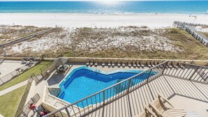 A swimming pool with a view of the beach and ocean.