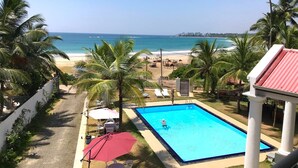 A swimming pool with a view of the beach and ocean. - Crystal Resort Dickwella (Dikwella)