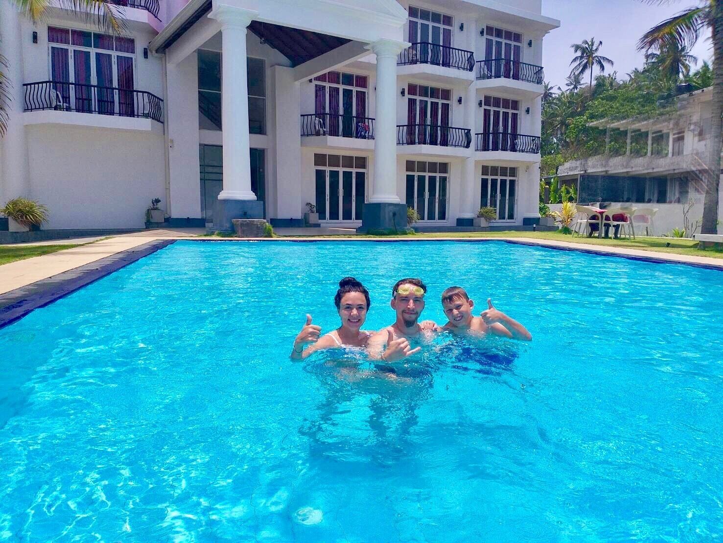 A swimming pool with a building in the background.