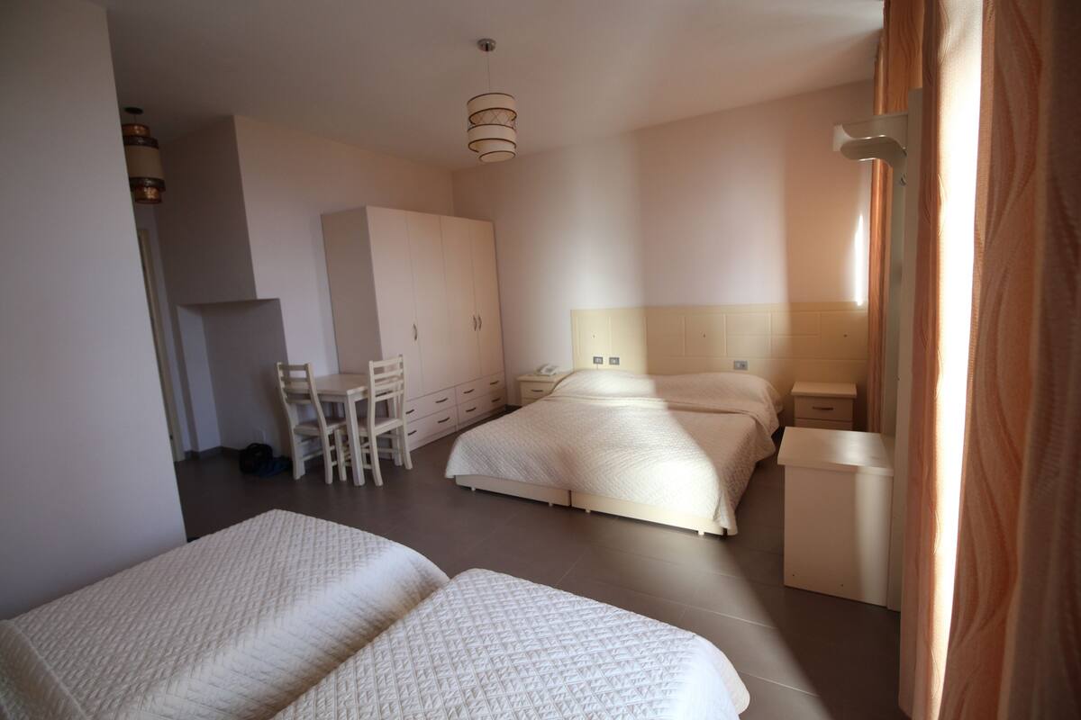 Comfort Triple Room, Garden View | Living area | Flat-screen TV, fireplace