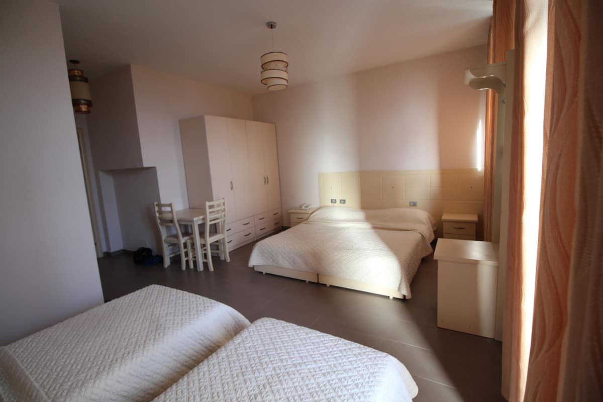 Comfort Triple Room, Garden View | Living area | Flat-screen TV, fireplace
