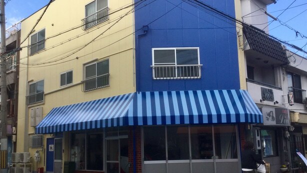 A building with a blue awning and a storefront. - PoshtelOsaka240 (Osaka)
