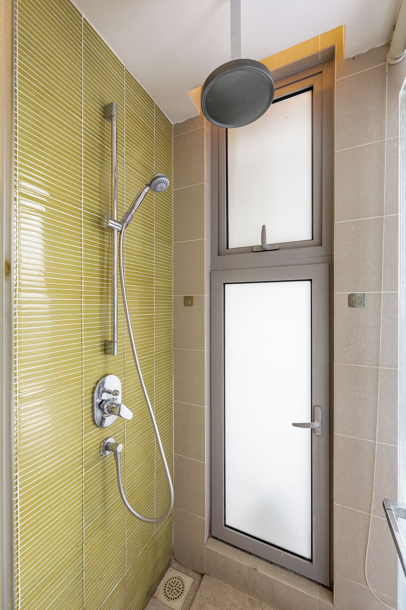 A bathroom with a shower, a toilet, and a sink.