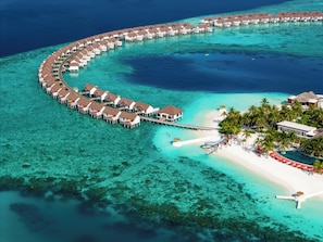 An aerial view of a resort with overwater bungalows connected by walkways, a beach area with palm trees, and clear turquoise waters. - OBLU SELECT Sangeli - Premium All Inclusive with Free Transfers (Akirifushi)