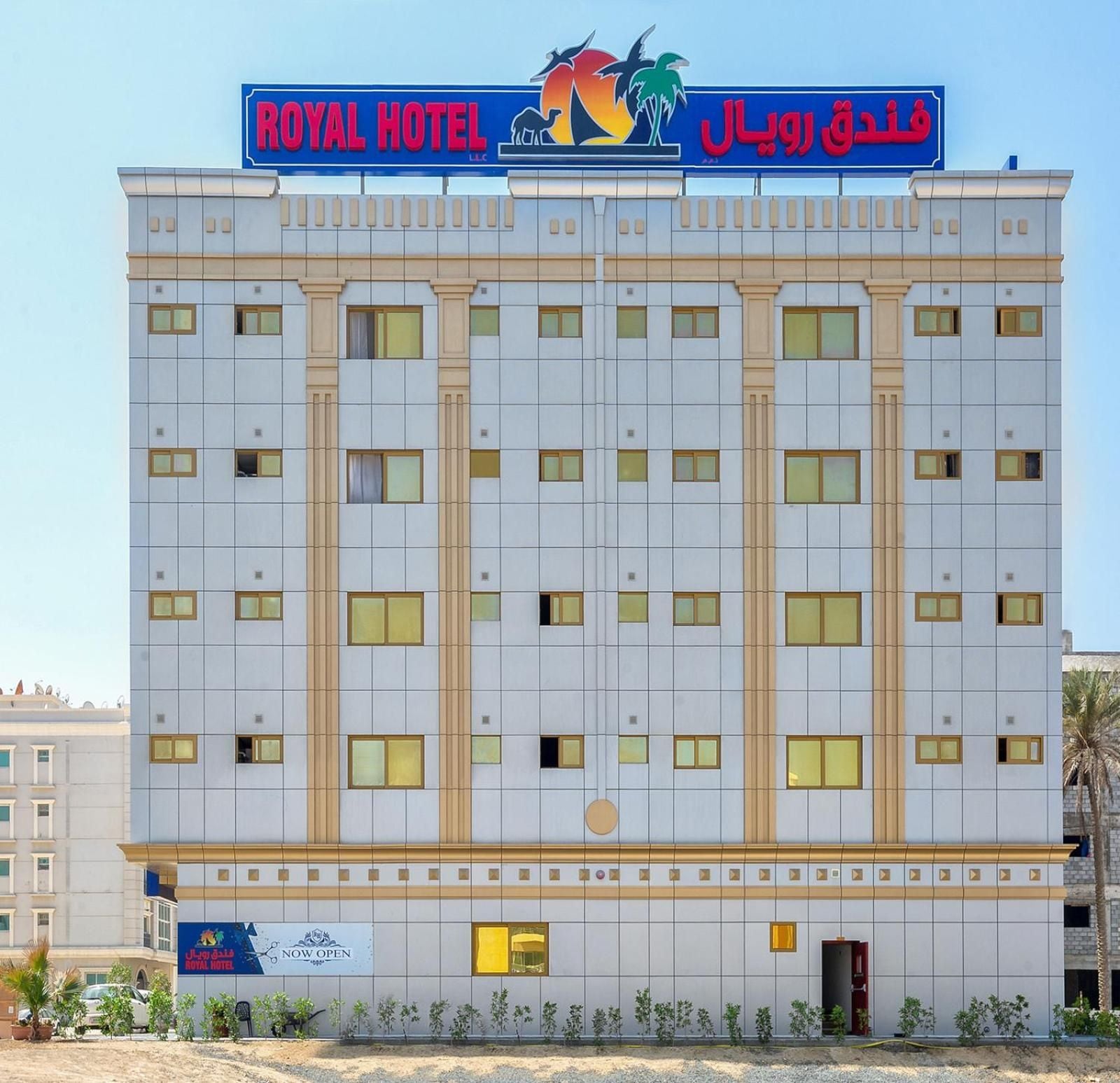 A hotel building with a sign indicating it's now open.