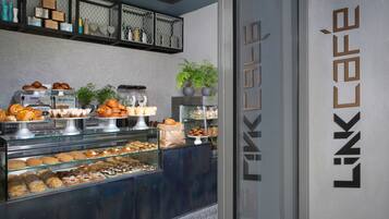 A display of pastries and baked goods in a café setting.
