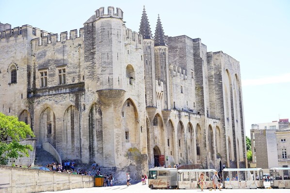 A historic stone building with arched windows and a central tower.