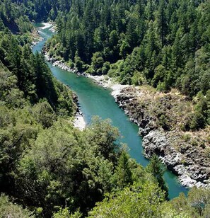 A river winding through a densely forested valley.