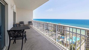 A balcony with a view of the ocean and a pool area. - Crystal Tower 1509 - Luxurious 15th Floor Corner Condo with Breathtaking Views (Gulf Shores)