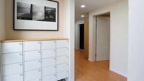 A hallway with a white cabinet and a framed photograph on the wall.
