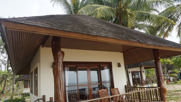A wooden structure with a balcony, large windows, and a view of the surrounding greenery. - Anandah Beach Resort (Takua Pa)