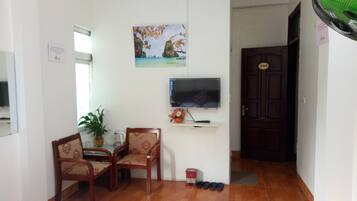 Standard Double Room | Living room | Flat-screen TV