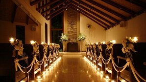 A church interior with pews lined up on either side, leading to a central altar. - Akiu Resort Hotel Crescent (Sendai)