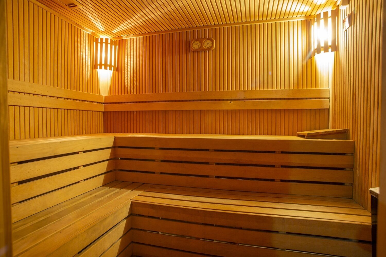 A sauna with wooden benches and slatted walls.