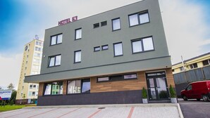 A modern hotel building with a flat roof, multiple windows, and a sign indicating it is Hotel 53. - Hotel & Bistro 63 (Poprad)
