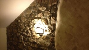 A stone wall with a light fixture embedded in it.