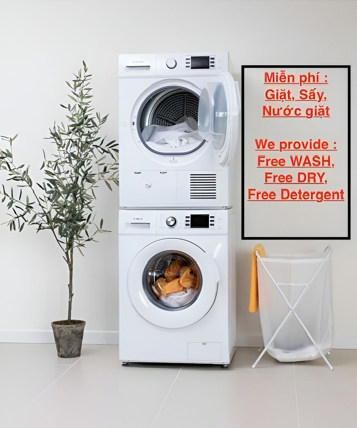 A stacked washer and dryer unit with a potted plant beside it and a drying rack to the right.