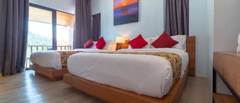 A hotel room with two beds, a large window with curtains, a painting on the wall, and a wooden floor.