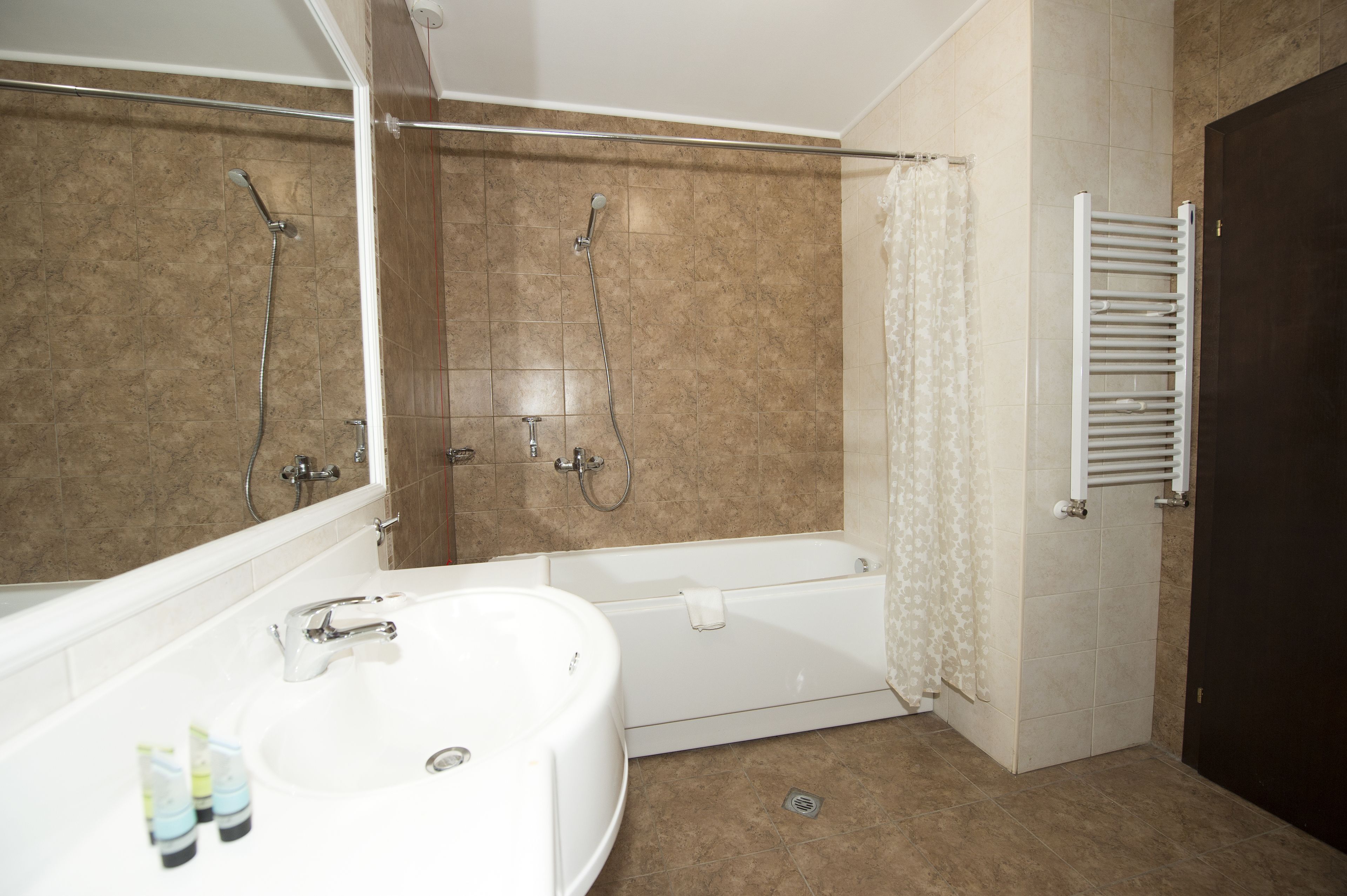 A bathroom with a bathtub, a shower, and a toilet.