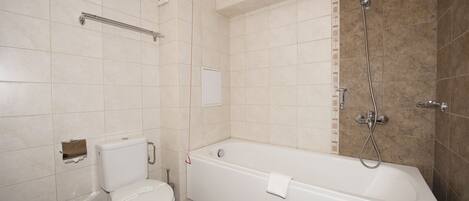 A bathroom with a toilet, a bathtub, and a shower.