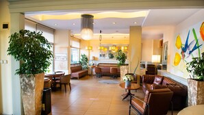 A spacious lobby with a seating area, large potted plants, and a modern chandelier. - Hotel Simsek (Edirne)