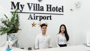 A reception desk at My Villa Hotel Airport with a sign above displaying the hotel name. - My Villa Hotel Airport (Ho Chi Minh City)