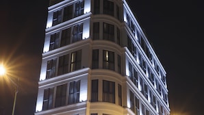 A multi-story hotel with a prominent illuminated sign reading "MAI VILLA HOTEL". - My Villa Hotel Airport (Ho Chi Minh City)