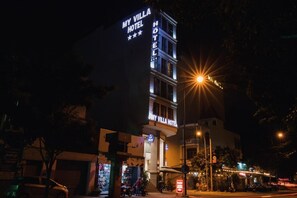 A multi-story hotel with illuminated signage, a visible entrance, and a street view at night. - My Villa Hotel Airport (Ho Chi Minh City)