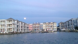 A waterfront residential area with multi-story buildings, docks, and a calm water body.