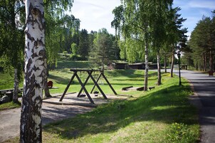 A park with a swing set, benches, and a path.