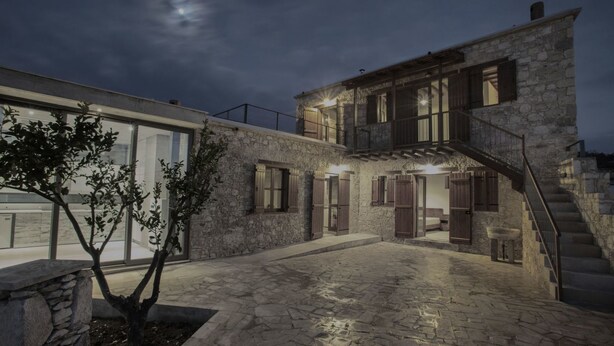 A stone building with a staircase, a tree, and a moon in the sky. - Marmaras (Lysos)